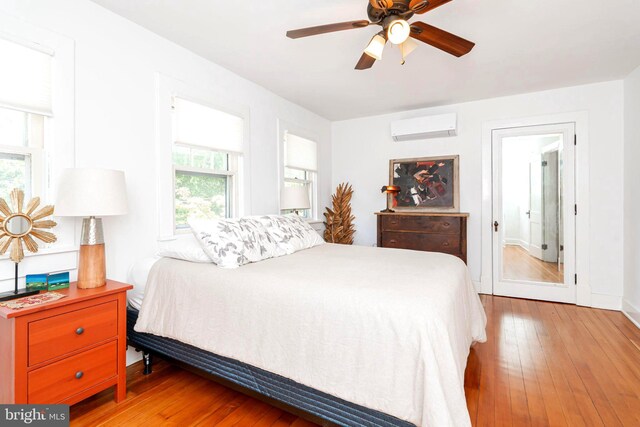 730 Fillmore St, Harpers Ferry, WV 25425 - bedroom with an AC wall unit, hardwood / wood-style flooring, baseboards, and a ceiling fan