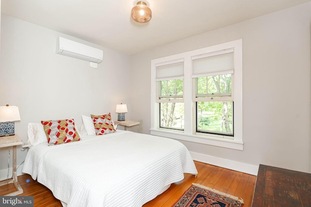 730 Fillmore St, Harpers Ferry, WV 25425 - bedroom with a wall unit AC, hardwood / wood-style flooring, and baseboards