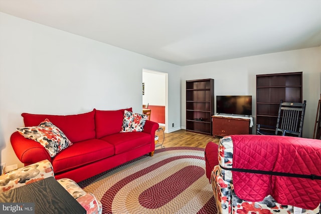 living area with wood finished floors and baseboards