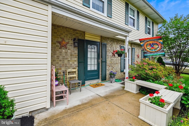 property entrance featuring brick siding