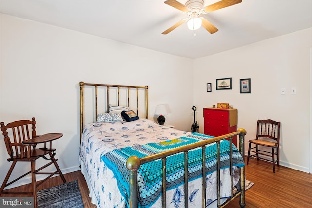 bedroom featuring wood finished floors, baseboards, and a ceiling fan