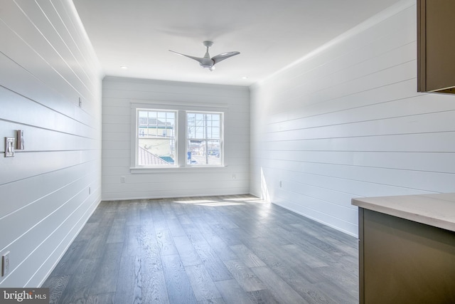 1306 N Barnegat Ave, Surf City, NJ 08008 - unfurnished dining area with ceiling fan, wood finished floors, and wooden walls