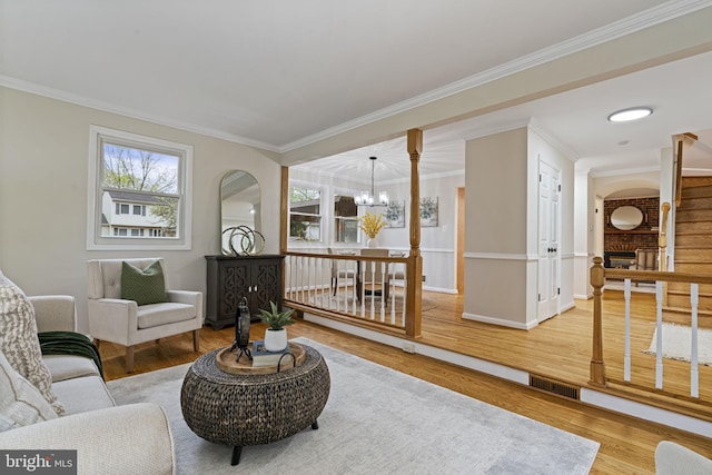 14906 Cranoke St, Centreville, VA 20120 - living room featuring a chandelier, crown molding, plenty of natural light, and wood finished floors