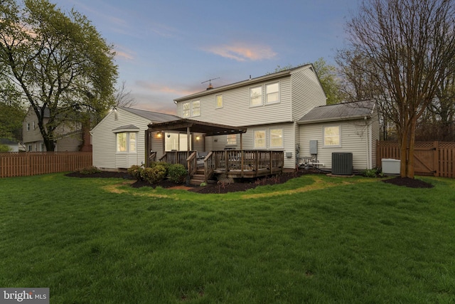 14906 Cranoke St, Centreville, VA 20120 - back of house at dusk featuring central AC unit, a wooden deck, and a gate