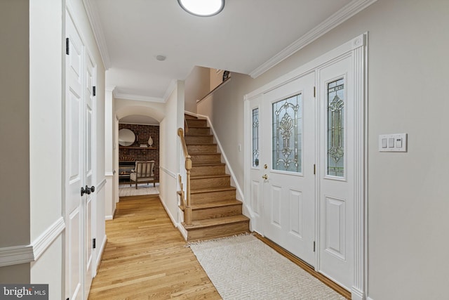 14906 Cranoke St, Centreville, VA 20120 - foyer entrance featuring light wood-style floors, stairs, ornamental molding, and arched walkways
