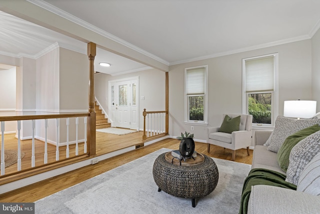 14906 Cranoke St, Centreville, VA 20120 - living room with wood finished floors, crown molding, stairs, baseboards, and ornate columns