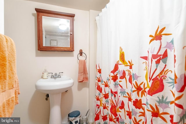 full bathroom with a sink and curtained shower