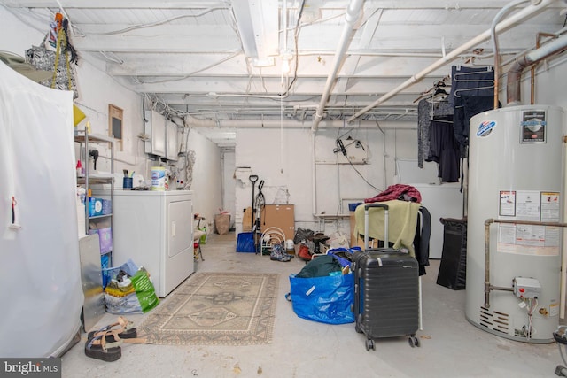 unfinished below grade area with gas water heater and washer / clothes dryer