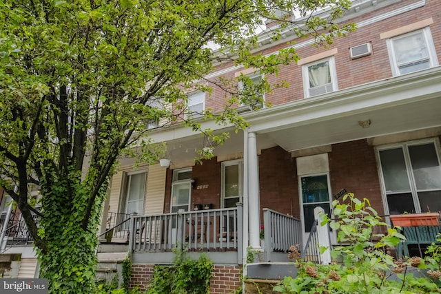view of front of property with covered porch and brick siding