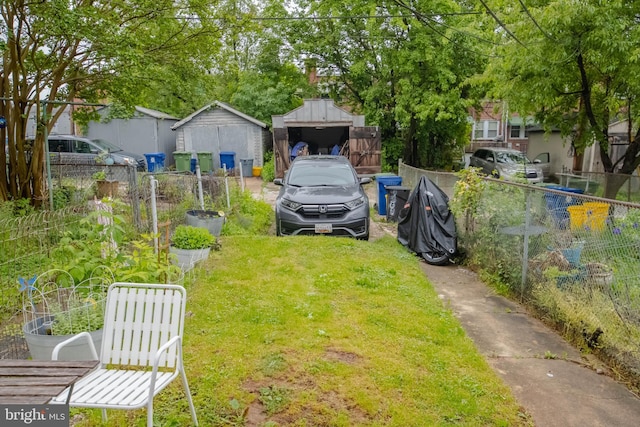view of yard with an outdoor structure, a shed, and a garden