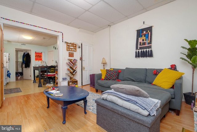 living room featuring a paneled ceiling and wood finished floors