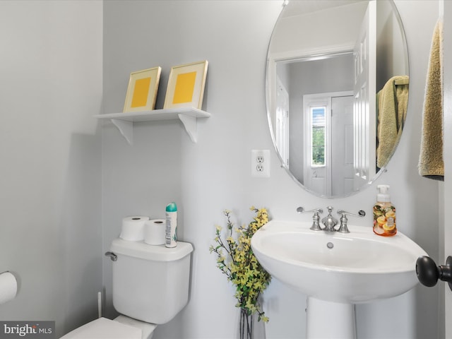 bathroom with toilet and a sink