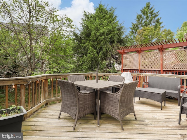 wooden terrace featuring a pergola and outdoor dining area