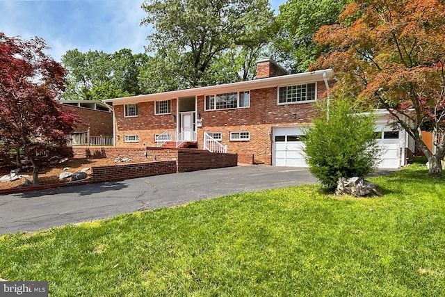 4124 Watkins Trl, Annandale, VA 22003 - bi-level home with asphalt driveway, a chimney, an attached garage, a front lawn, and brick siding