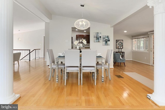 4124 Watkins Trl, Annandale, VA 22003 - dining area with wood finished floors, vaulted ceiling, a chandelier, decorative columns, and baseboards