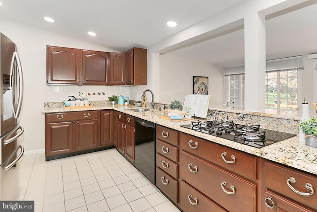 4124 Watkins Trl, Annandale, VA 22003 - kitchen with black appliances, a sink, light stone counters, light tile patterned floors, and recessed lighting