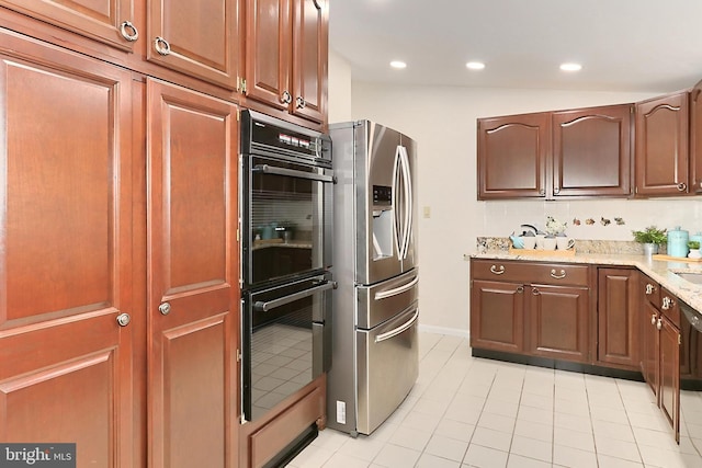4124 Watkins Trl, Annandale, VA 22003 - kitchen with stainless steel refrigerator with ice dispenser, double oven, light stone countertops, light tile patterned floors, and recessed lighting