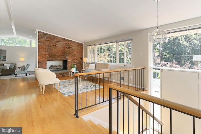 4124 Watkins Trl, Annandale, VA 22003 - stairs with vaulted ceiling, wood finished floors, plenty of natural light, a chandelier, and a brick fireplace