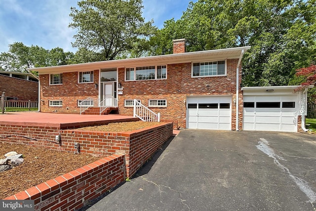 4124 Watkins Trl, Annandale, VA 22003 - raised ranch featuring driveway, a chimney, brick siding, and a garage