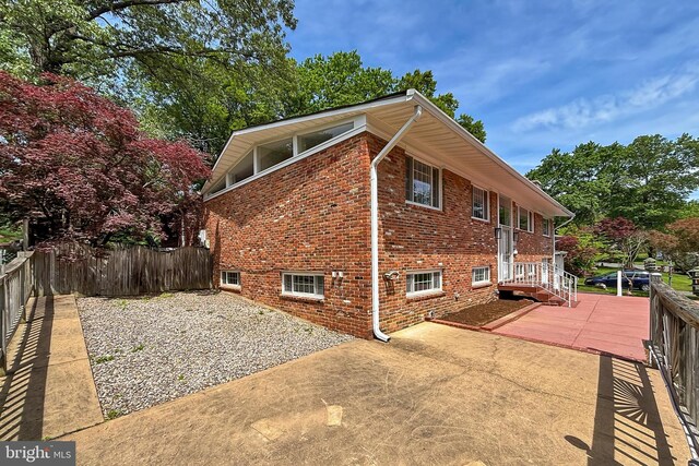 4124 Watkins Trl, Annandale, VA 22003 - view of side of home featuring a patio, brick siding, and fence