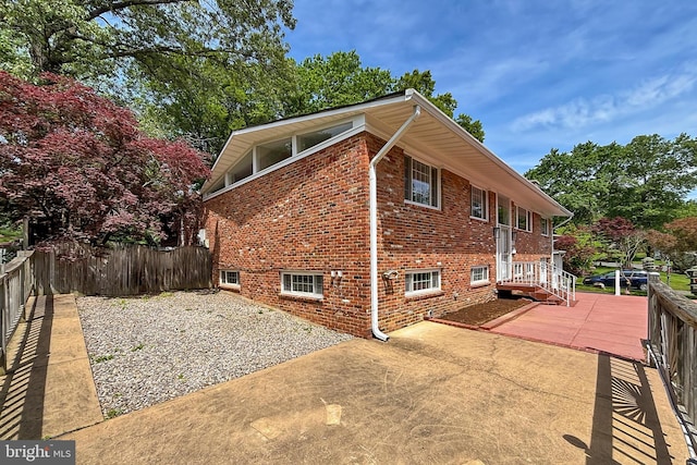 4124 Watkins Trl, Annandale, VA 22003 - view of property exterior with a patio area, brick siding, and fence
