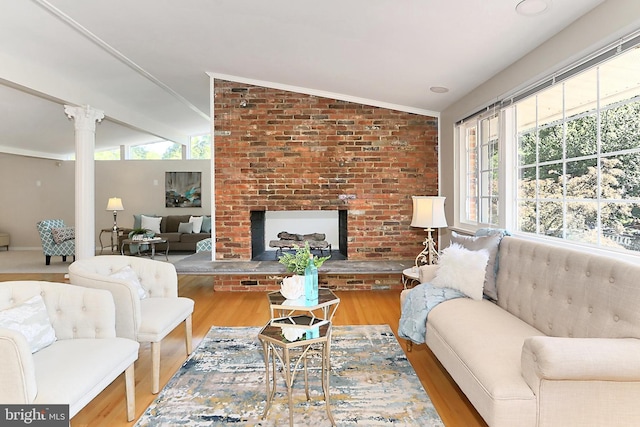 4124 Watkins Trl, Annandale, VA 22003 - living room featuring vaulted ceiling, wood finished floors, crown molding, and a brick fireplace