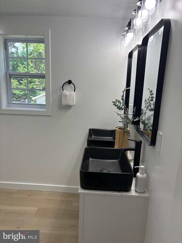 2506 Chelsea Ter, Baltimore, MD 21216 - bathroom featuring wood finished floors, baseboards, and vanity