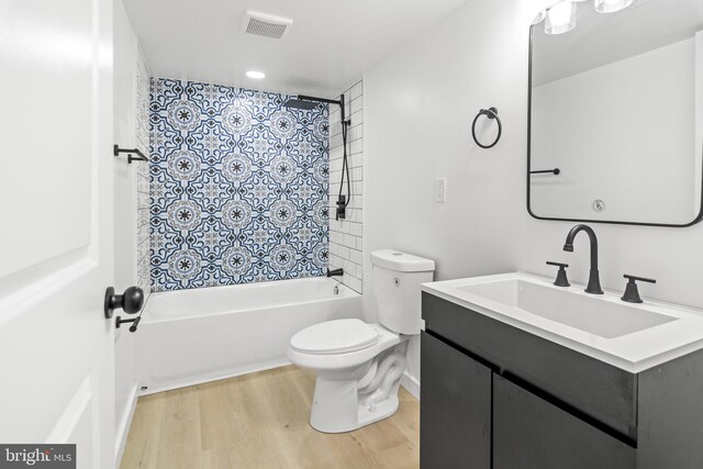 2506 Chelsea Ter, Baltimore, MD 21216 - bathroom featuring wood finished floors, toilet, shower / bath combination with curtain, and vanity