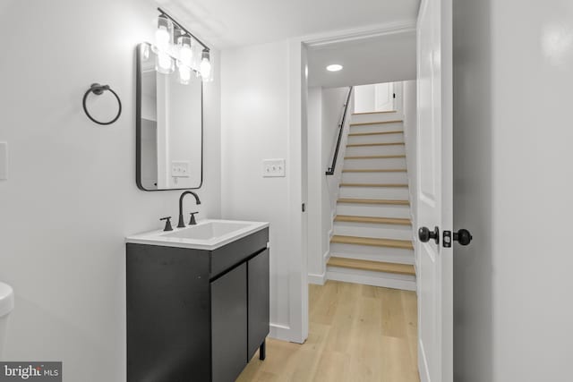 2506 Chelsea Ter, Baltimore, MD 21216 - bathroom with wood finished floors, vanity, and recessed lighting