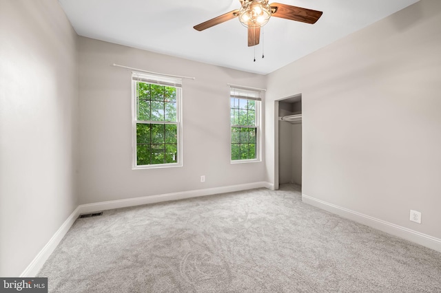 unfurnished bedroom featuring carpet, a closet, and baseboards