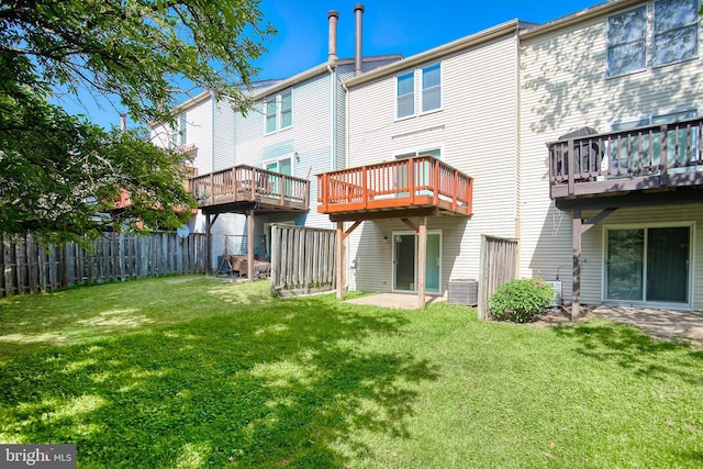 rear view of house with central air condition unit and a wooden deck