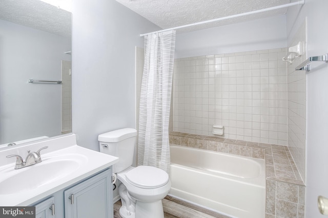 bathroom with a textured ceiling, shower / bath combination with curtain, toilet, and vanity