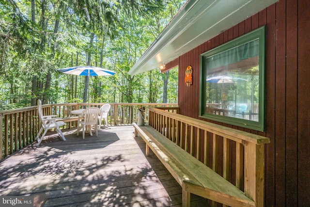 wooden terrace with outdoor dining area
