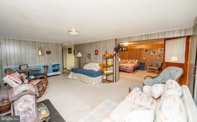 carpeted bedroom with wooden walls