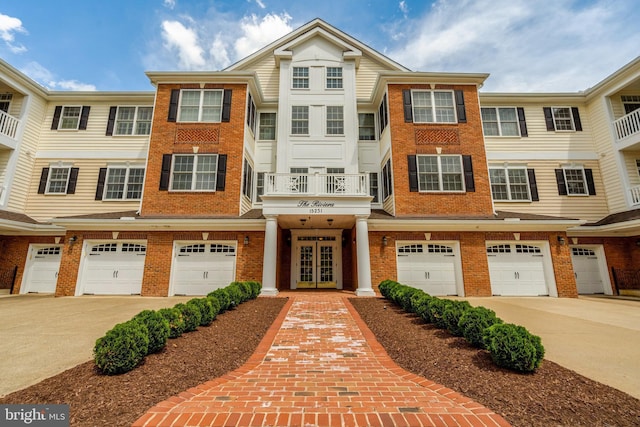 multi unit property featuring brick siding and an attached garage