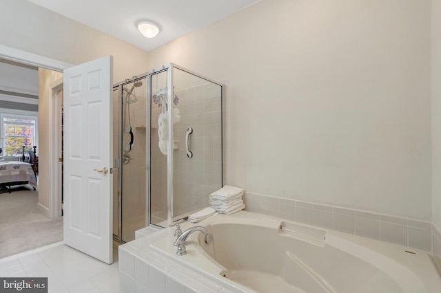 ensuite bathroom featuring a shower stall, a bath, and tile patterned floors