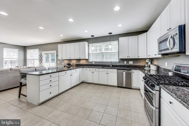 2307 Springdale Ln, Waldorf, MD 20603 - kitchen featuring appliances with stainless steel finishes, a peninsula, open floor plan, white cabinets, and recessed lighting