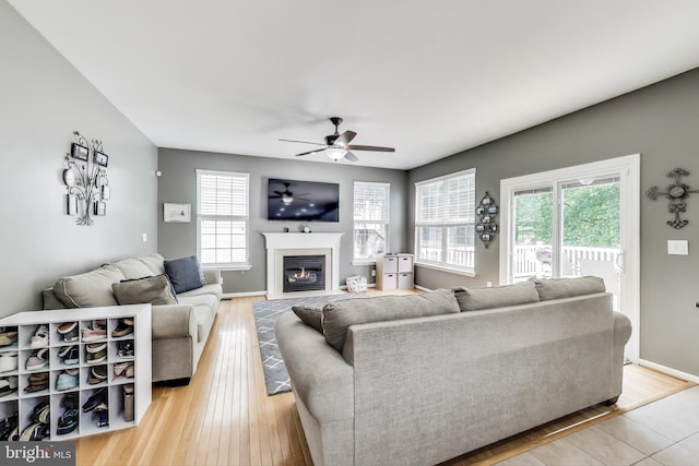 2307 Springdale Ln, Waldorf, MD 20603 - living area featuring healthy amount of natural light, a ceiling fan, a fireplace with flush hearth, and light wood finished floors