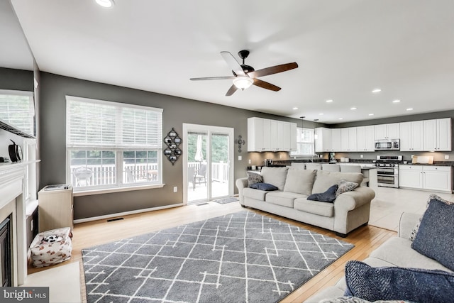 2307 Springdale Ln, Waldorf, MD 20603 - living room featuring a ceiling fan, light wood finished floors, recessed lighting, and a fireplace