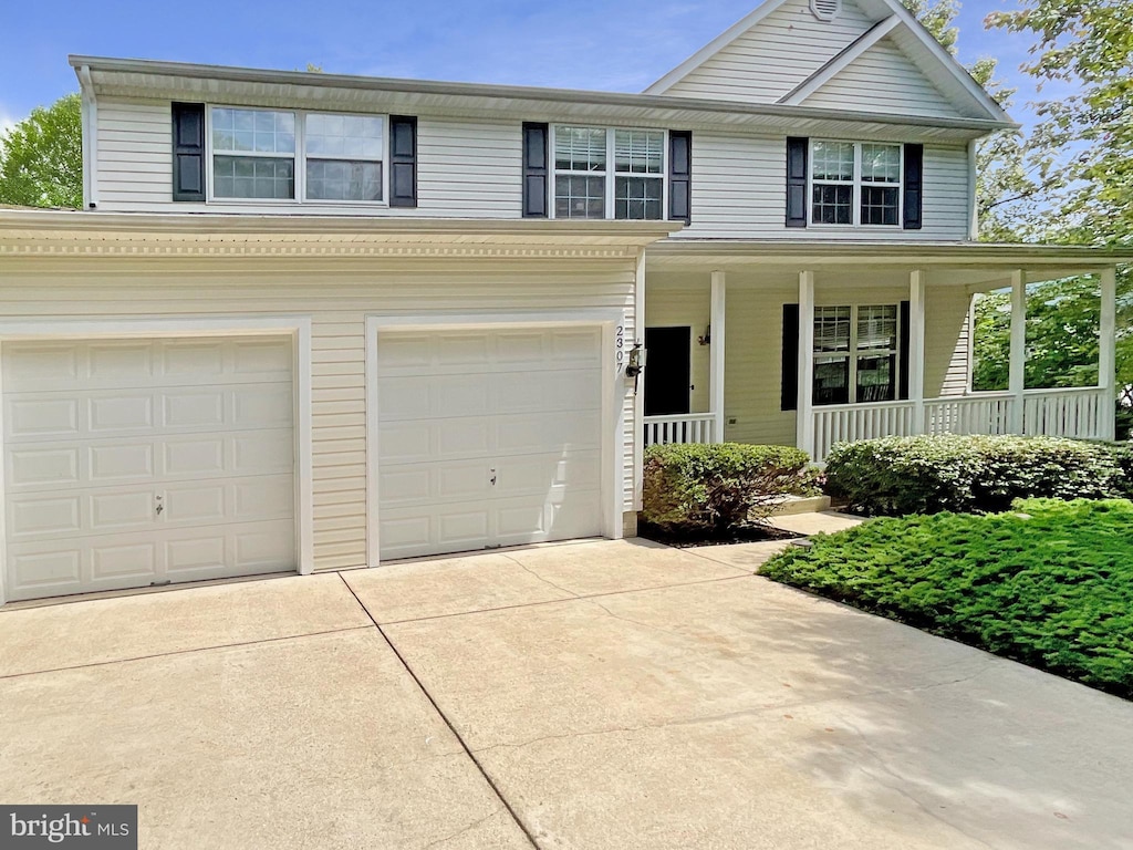 2307 Springdale Ln, Waldorf, MD 20603 - traditional home featuring concrete driveway, a porch, and an attached garage