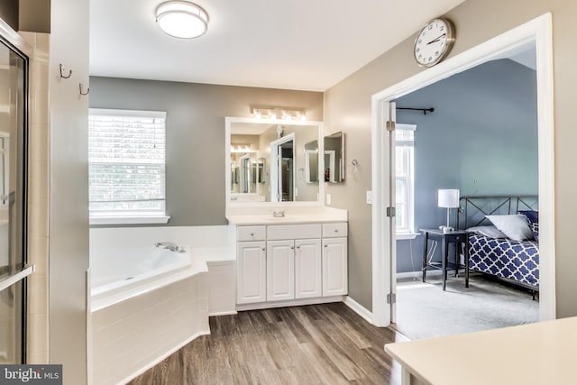 2307 Springdale Ln, Waldorf, MD 20603 - ensuite bathroom featuring vanity, a garden tub, wood finished floors, and a shower with door