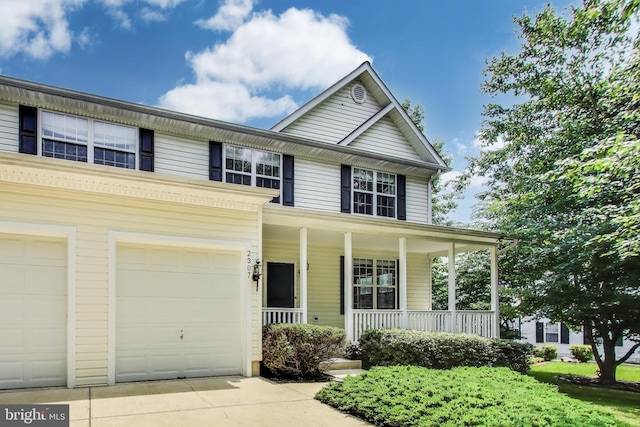 2307 Springdale Ln, Waldorf, MD 20603 - view of front of home featuring covered porch, concrete driveway, and a garage