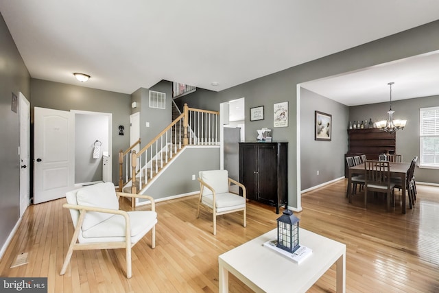 2307 Springdale Ln, Waldorf, MD 20603 - living area with light wood finished floors, a chandelier, and stairway