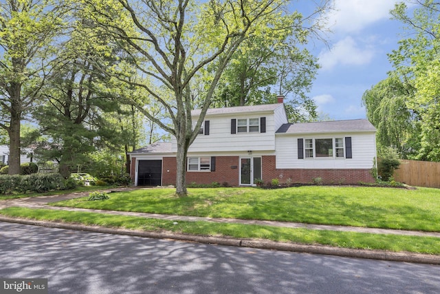 view of front of house with brick siding, a garage, driveway, and a chimney