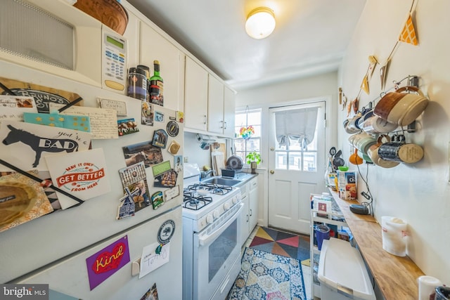 2217 Observatory Pl NW, Washington, DC 20007 - kitchen featuring white appliances, white cabinetry, a sink, and light floors