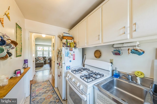 2217 Observatory Pl NW, Washington, DC 20007 - kitchen featuring white appliances, a sink, white cabinetry, and light countertops