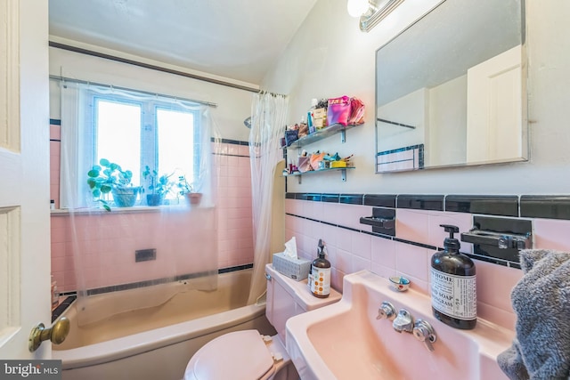 2217 Observatory Pl NW, Washington, DC 20007 - bathroom with tile walls, toilet, shower / bath combo with shower curtain, and a sink