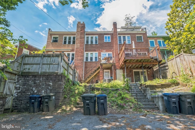 2217 Observatory Pl NW, Washington, DC 20007 - back of property with stairs, brick siding, a fenced backyard, a deck, and a chimney