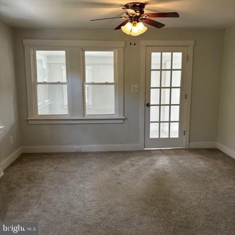 doorway to outside with carpet floors, ceiling fan, and baseboards