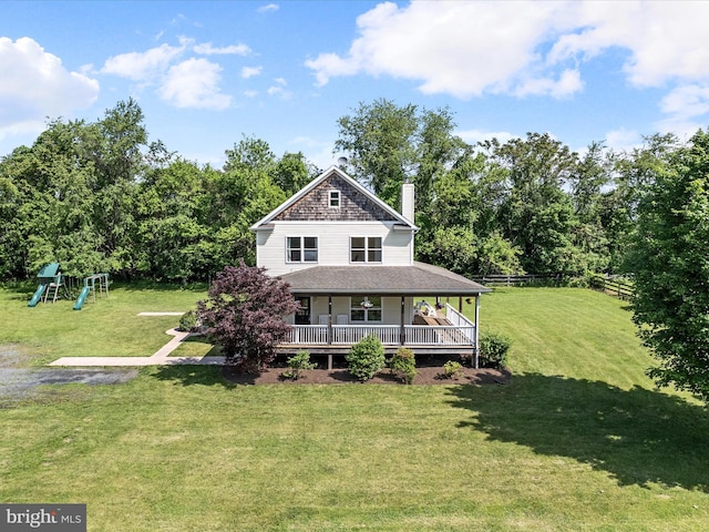 country-style home featuring a playground, a chimney, a deck, and a shingled roof